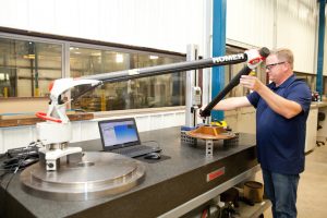 One of our quality techs using the Romer Arm for part inspection